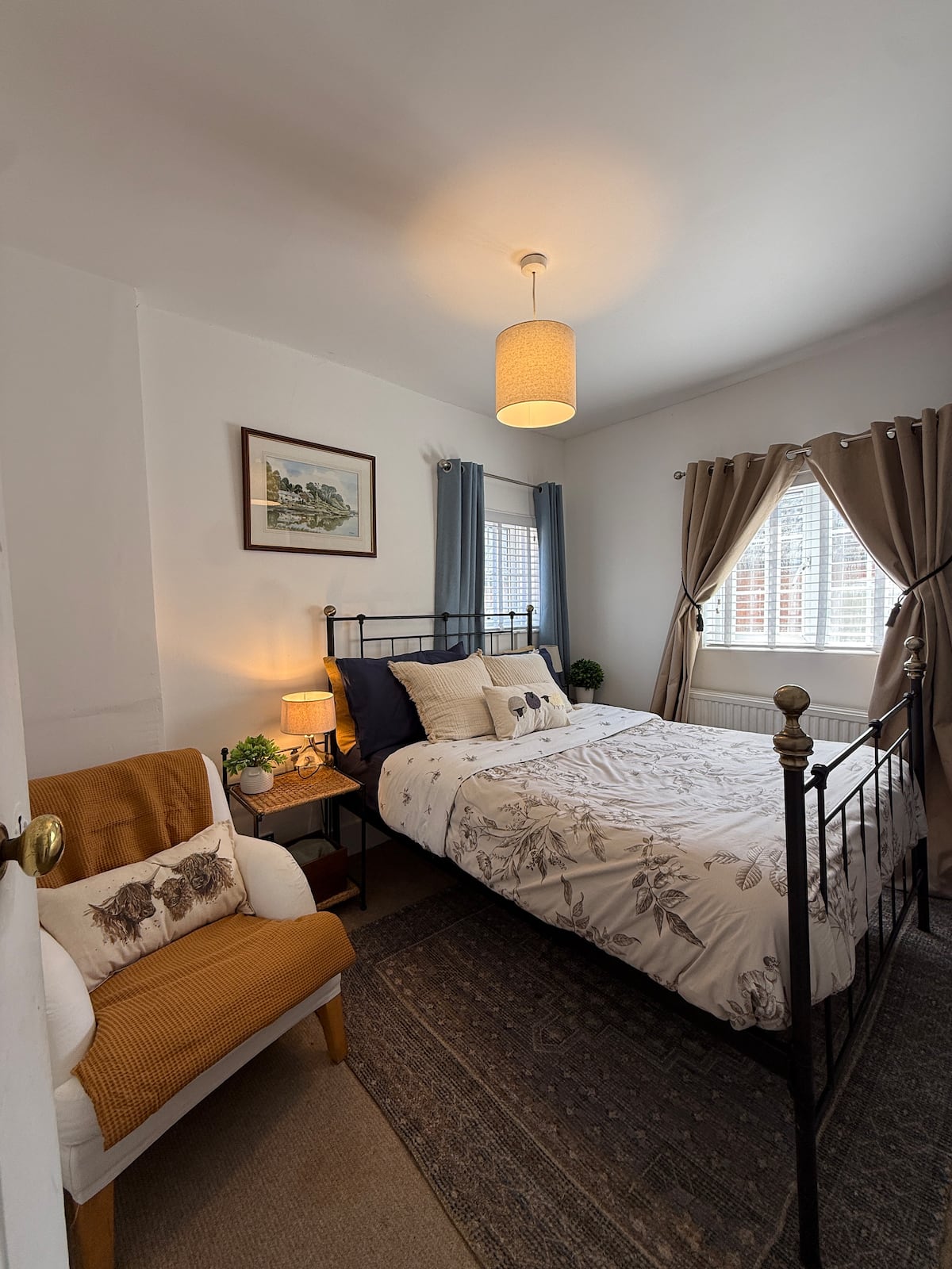 Bedroom with wrought-iron bed and warm lighting